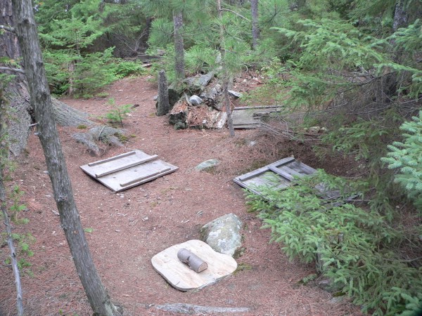 Take a guess what's under these four wooden covers in front of the cabin